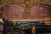 Wat Xieng Thong temple in Luang Prabang, Laos.  La Chapelle Rouge , the Red Chapel. The reclining Buddha bronze sculpture that dates from the construction of the temple. 